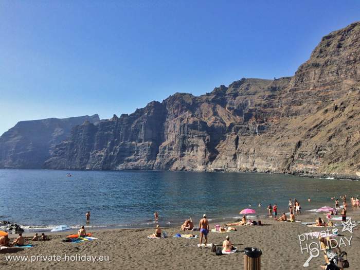Black beach with high cliffs and swimmers, Los Gigantes, Tenerife