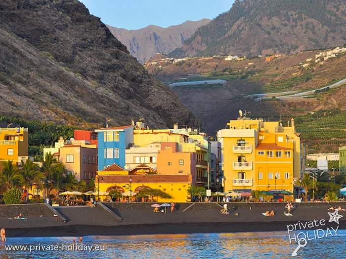 Colorful houses on black beach before steep mountains, Tazacorte